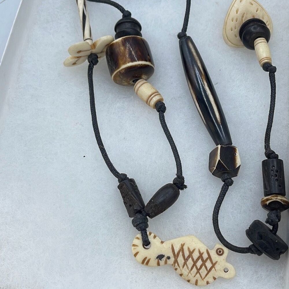 Ethnic hand carved wood black cord necklace.